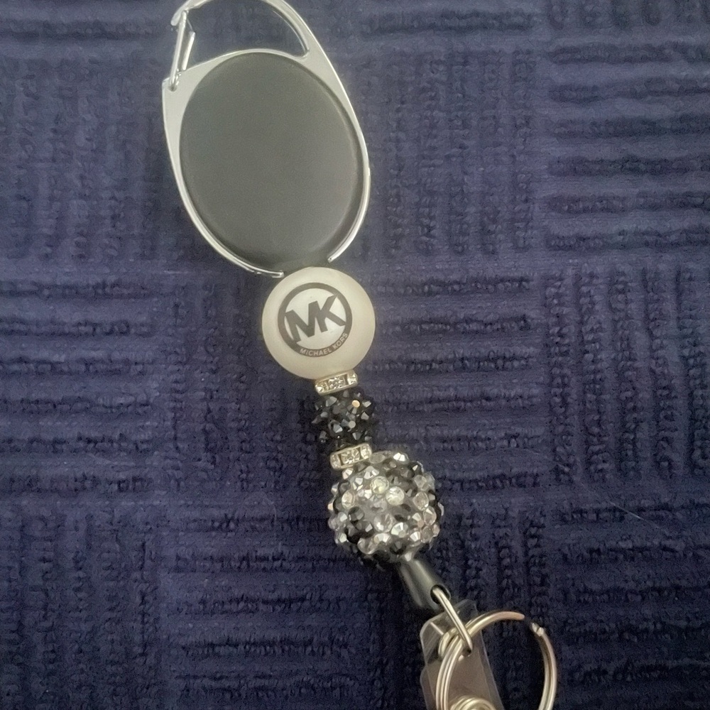Michael Kors Badge Reel with Black and Silver Accents